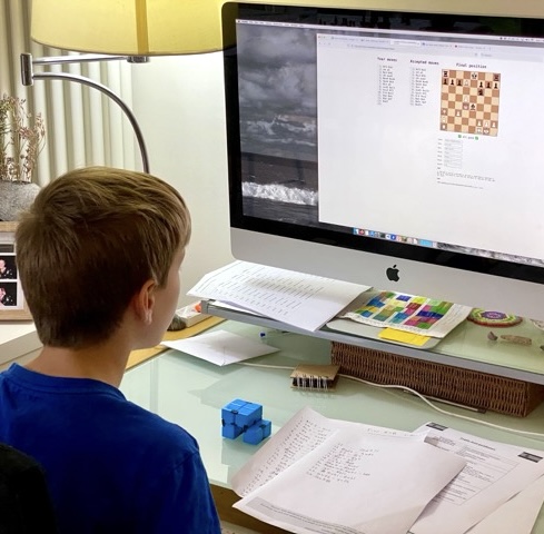 Child entering chess moves from paper